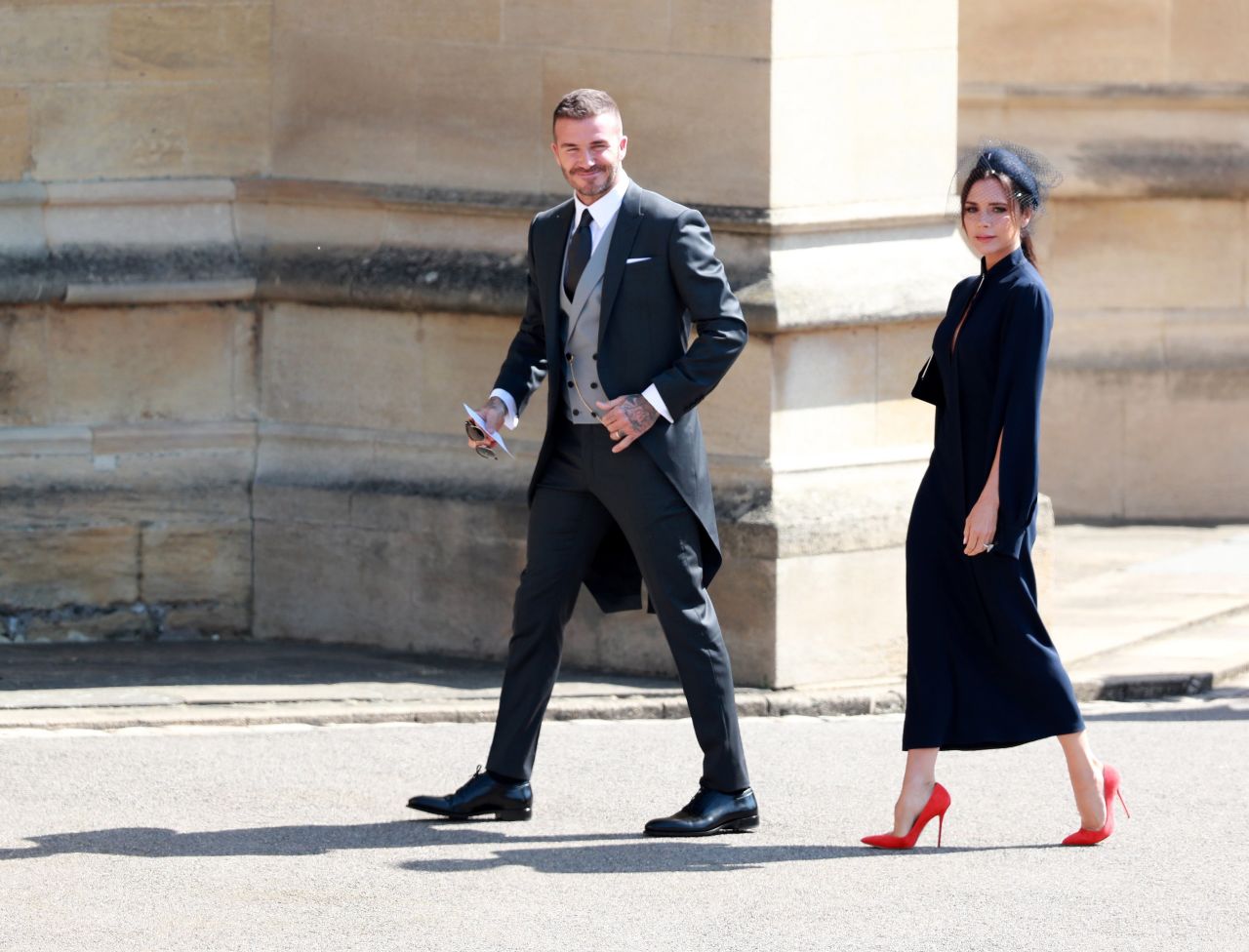 Victoria Beckham, wearing her own label, and her husband, David Beckham