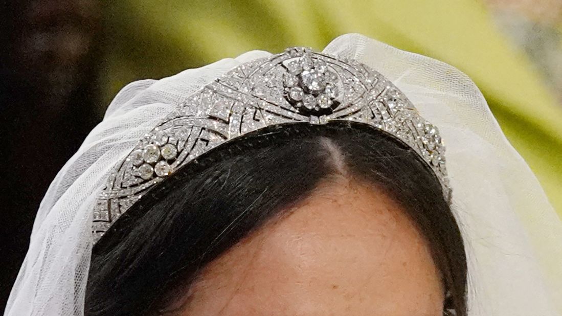 The veil is held in place by Queen Mary's diamond bandeau tiara, on loan from the Queen. Crafted in 1932, the diamond bandeau features a center brooch dating from 1893.