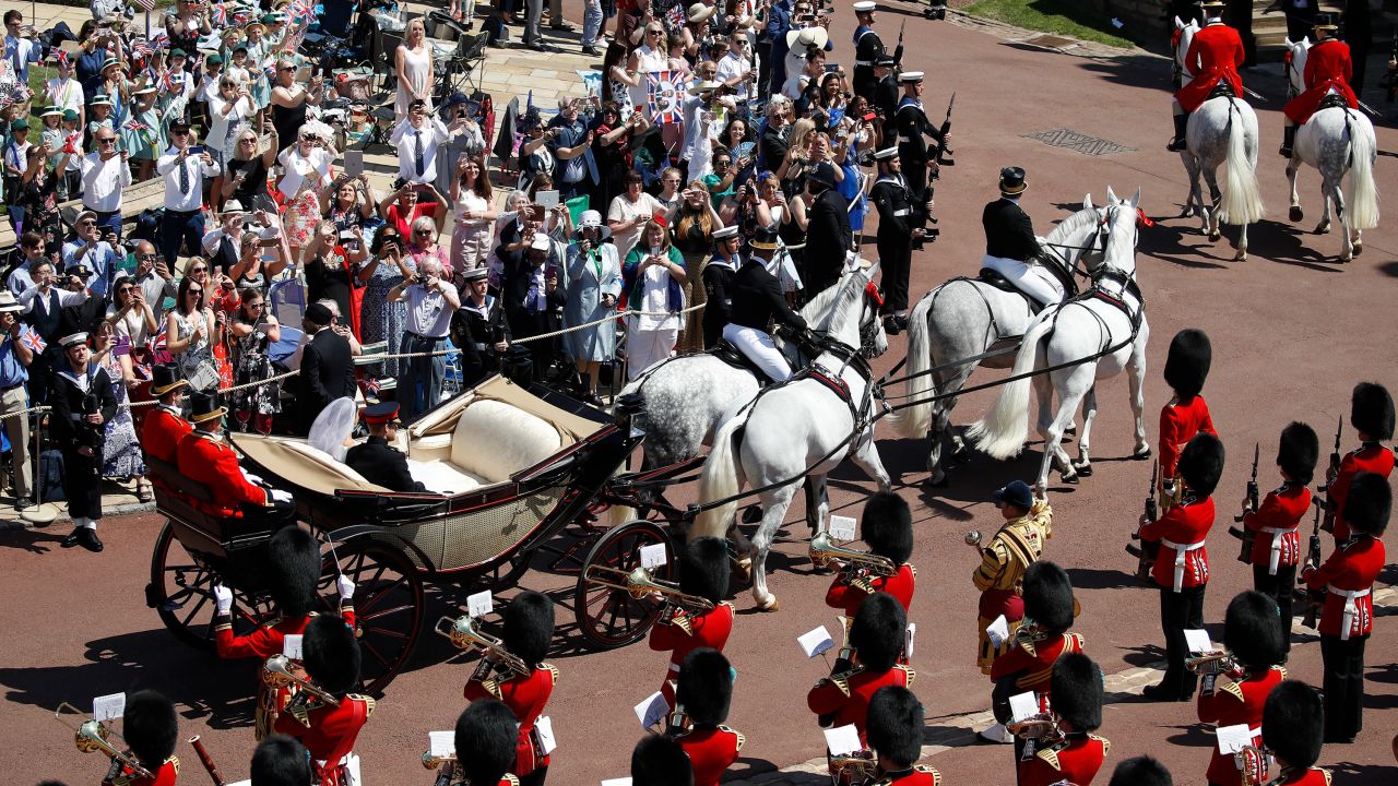 Crowds line the route to catch a glimpse of the couple.
