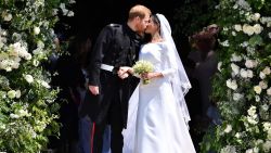 Britain's Prince Harry, Duke of Sussex kisses his wife Meghan, Duchess of Sussex as they leave from the West Door of St George's Chapel, Windsor Castle, in Windsor, on May 19, 2018 after their wedding ceremony. (Photo by Ben STANSALL / POOL / AFP)        (Photo credit should read BEN STANSALL/AFP/Getty Images)