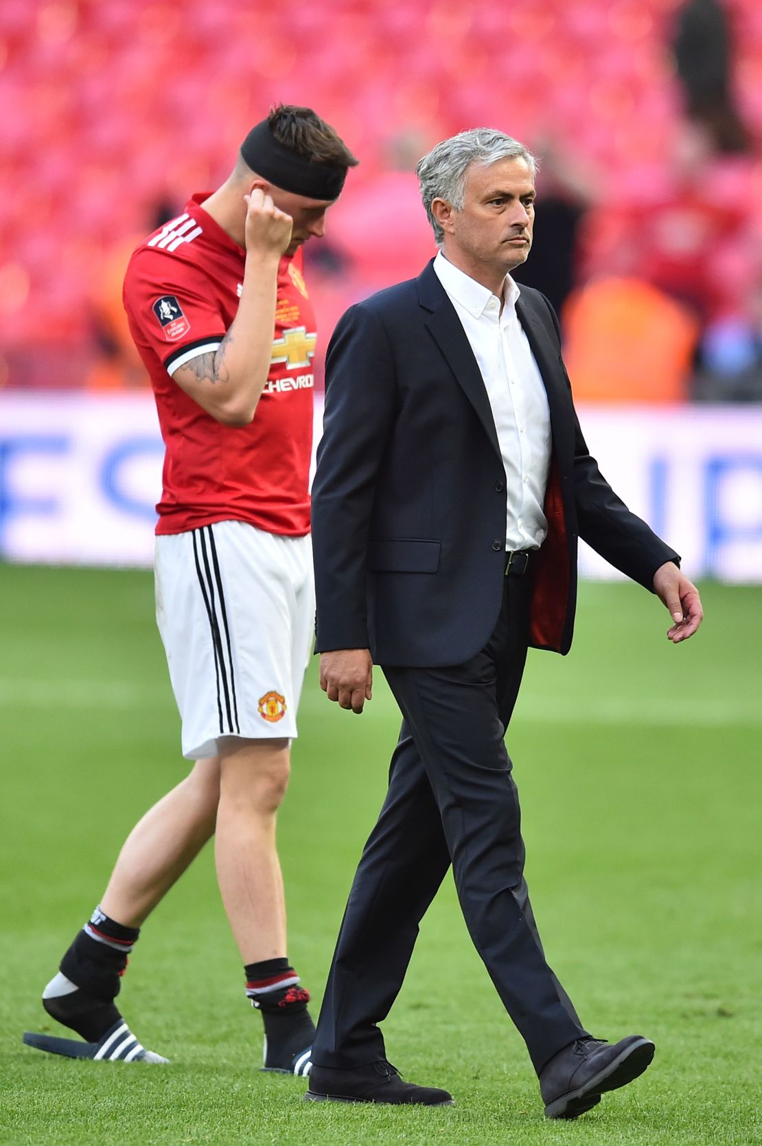 Manchester United's Portuguese manager Jose Mourinho and defender Phil Jones cut dejected figures after the final defeat at Wembley.