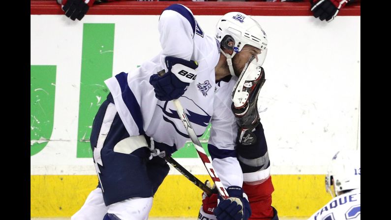 Chris Kunitz, No. 14 of the Tampa Bay Lightning, gets kicked in the face against the Washington Capitals during the third period in Game Four of the Eastern Conference Finals during the 2018 NHL Stanley Cup Playoffs at Capital One Arena on Thursday, May 17, in Washington.  