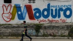A man walks past a graffiti in support of Venezuelan President Nicolas Maduro, in Barquisimeto, Venezuela, on May 19, 2018 on the eve of the country's presidential election. - Venezuela holds presidential elections on May 20, in which Maduro is seeking a second six-year term. (Photo by Luis ROBAYO / AFP)        (Photo credit should read LUIS ROBAYO/AFP/Getty Images)