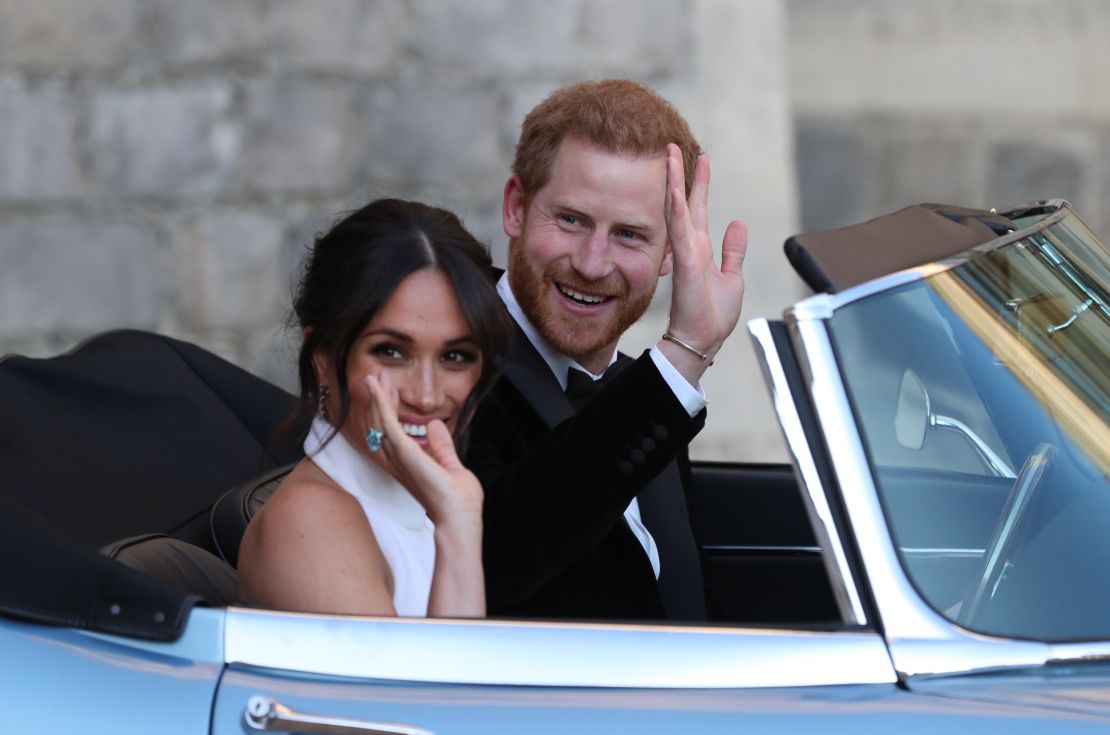 The Duke and Duchess of Sussex wave as they leave Windsor Castle after their wedding to attend an evening reception at Frogmore House. The Duchess wore a ring that once belonged to Harry's mother, the late Diana, Princess of Wales. 