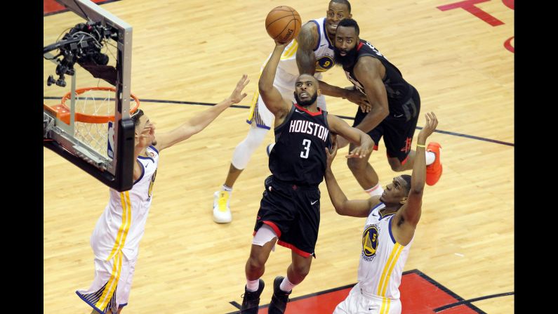 Houston Rockets guard Chris Paul (No. 3) shoots over Golden State Warriors guard Klay Thompson, left, and forward Kevon Looney (No. 5) during the second quarter in Game One of the Western Conference Finals of the 2018 NBA Playoffs at Toyota Center in Houston on Monday, May 14. 