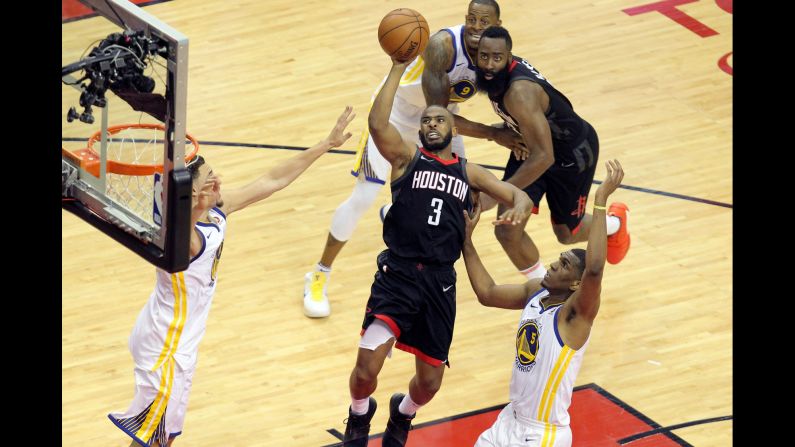 Houston Rockets guard Chris Paul (No. 3) shoots over Golden State Warriors guard Klay Thompson, left, and forward Kevon Looney (No. 5) during the second quarter in Game One of the Western Conference Finals of the 2018 NBA Playoffs at Toyota Center in Houston on Monday, May 14.