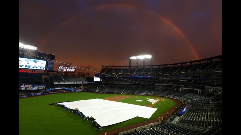 A rainbow is seen as the grounds crew removes the tarp before the start of the game between the New York Mets and the Toronto Blue Jays at Citi Field on Tuesday, May 15, in the Flushing neighborhood of the Queens borough of New York. <a href="index.php?page=&url=https%3A%2F%2Fwww.cnn.com%2F2018%2F05%2F13%2Fsport%2Fgallery%2Fwhat-a-shot-sports-0513%2Findex.html" target="_blank">See last week's best sports pictures </a>
