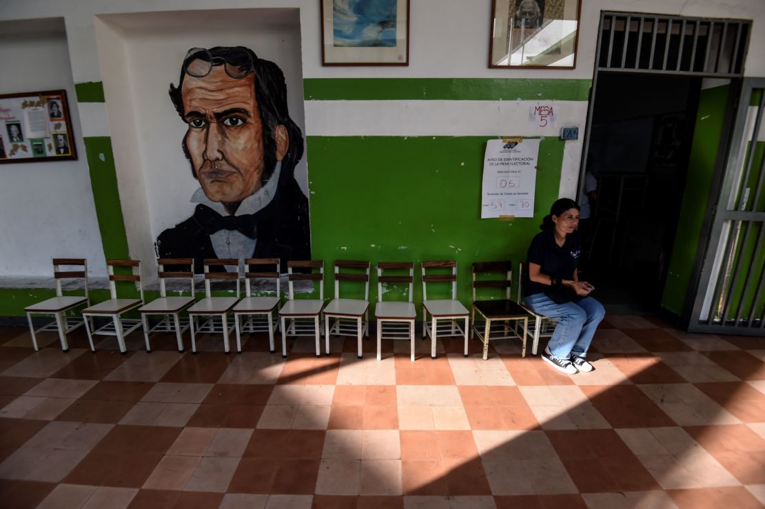 A Venezuelan woman waits at a near-empty polling station on Sunday.