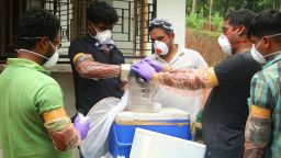 Animal Husbandry department and Forest officials deposit a bat into a container after catching it inside a well at Changaroth in Kozhikode in the Indian state of Kerala on May 21, 2018. - A deadly virus carried mainly by fruit bats has killed at least three people in southern India, sparking a statewide health alert May 21. Eight other deaths in the state of Kerala are being investigated for possible links to the Nipah virus, which has a 70 percent mortality rate. (Photo by - / AFP)        (Photo credit should read -/AFP/Getty Images)