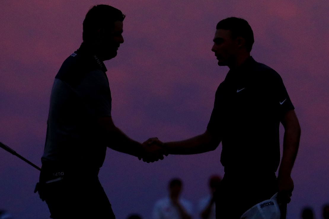 Marc Leishman (left) congratulates Aaron Wise on the 18th green after finishing their round.