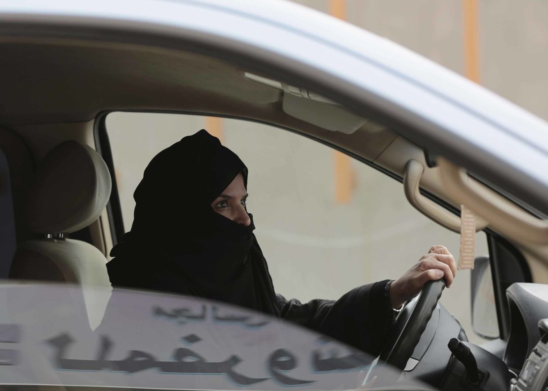 Aziza al-Yousef drives a car on a highway in Riyadh, Saudi Arabia, as part of a 2014 campaign to defy Saudi Arabia's ban on women driving. (AP Photo/Hasan Jamali, File)