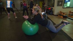 Julie Mignerey is doing a modified plank in her low impact, functional fitness class. 