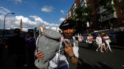 A Real Madrid football team fan holds a replica of the Champions League trophy in the surroundings of the Santiago Bernabeu stadium in Madrid on June 3, 2017 during the UEFA Champions League football match final Juventus vs Real Madrid CF held at the National Stadium of Wales in Cardiff. / AFP PHOTO / OSCAR DEL POZO        (Photo credit should read OSCAR DEL POZO/AFP/Getty Images)