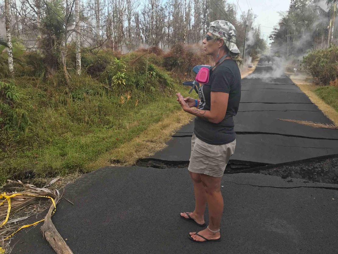 Stacy Welch surveys the cracks in road outside her home. 