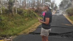 Stacy Welch surveys the cracks in road outside her home. 