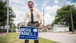 Democratic congressional candidate Archie Parnell places a campaign sign in the grass June 19, 2017 in Bishopville, South Carolina.
