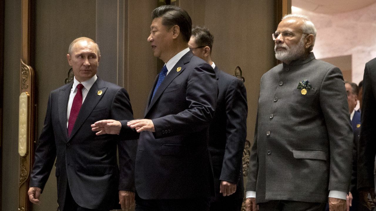 Russian President Vladimir Putin, Chinese President Xi Jinping and Indian Prime Minister Narendra Modi arrive for the Dialogue of Emerging Market and Developing Countries on the sidelines of the 2017 BRICS Summit in Xiamen, southeastern China's Fujian Province on September 5, 2017.
