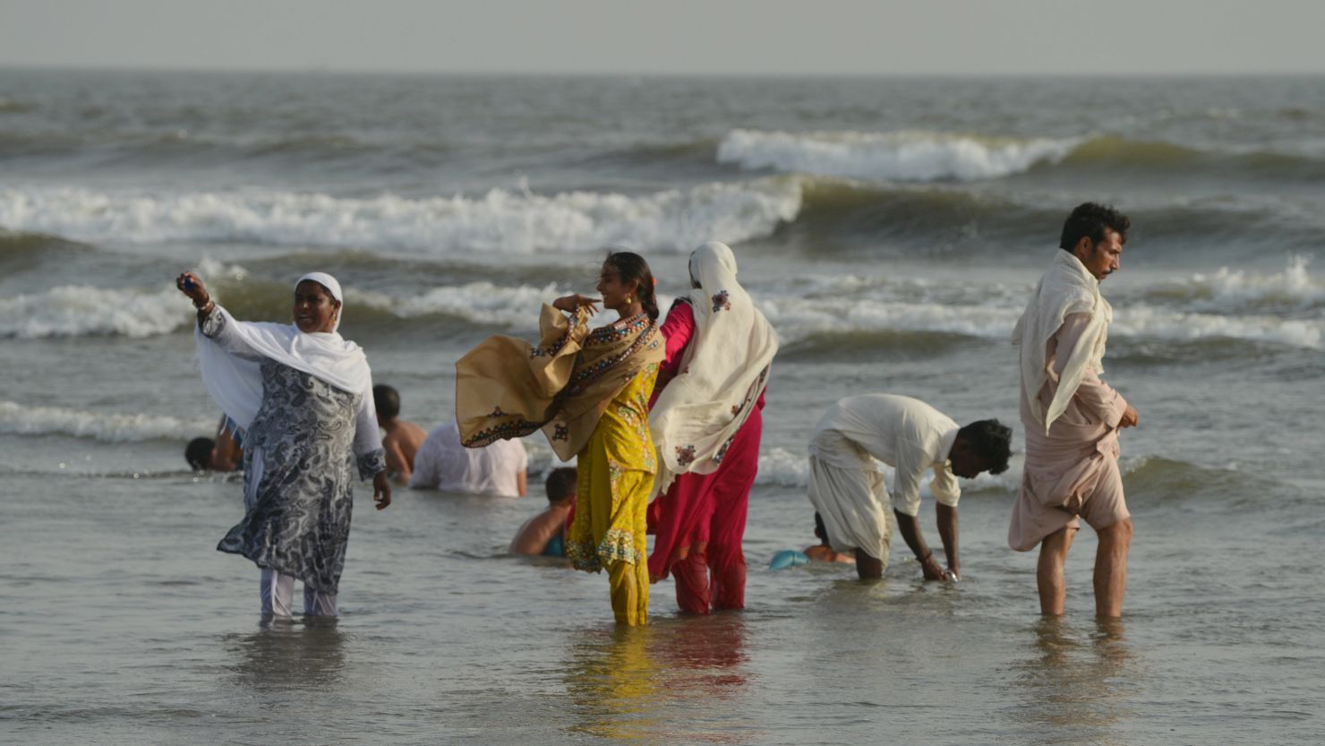 Pakistani residents cool off at Clifton beach during a heat wave in Karachi on May 21, 2018.