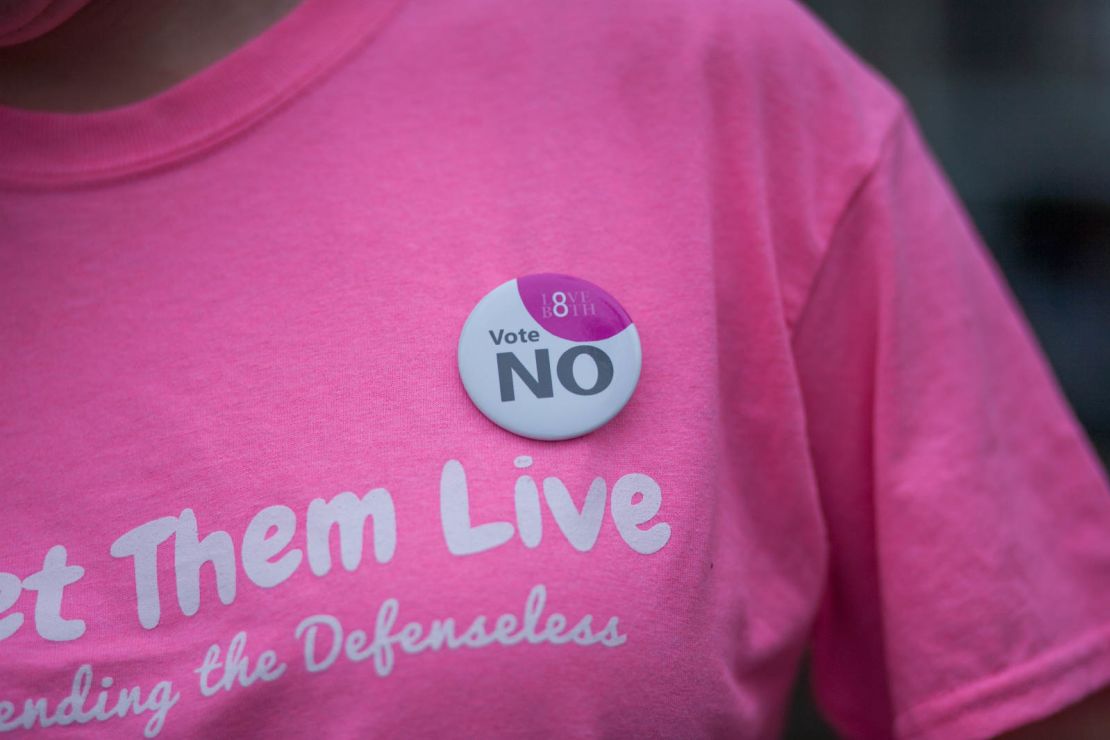 Faulkner wears an Irish 'Vote NO' badge on her Let Them Live shirt. Faulkner says the group's shirts were designed in pink to "reappropriate the color pink back from Planned Parenthood."
