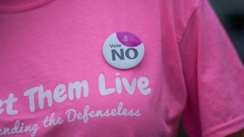 Faulkner wears an Irish 'Vote NO' badge on her Let Them Live shirt. Faulkner says the group's shirts were designed in pink to "reappropriate the color pink back from Planned Parenthood."
