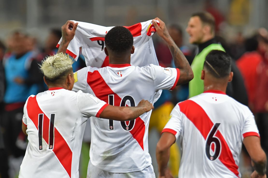 Peru's Raul Ruidiaz, Jefferson Farfan and Miguel Trauco hold aloft Guerrero's jersey during his absence.