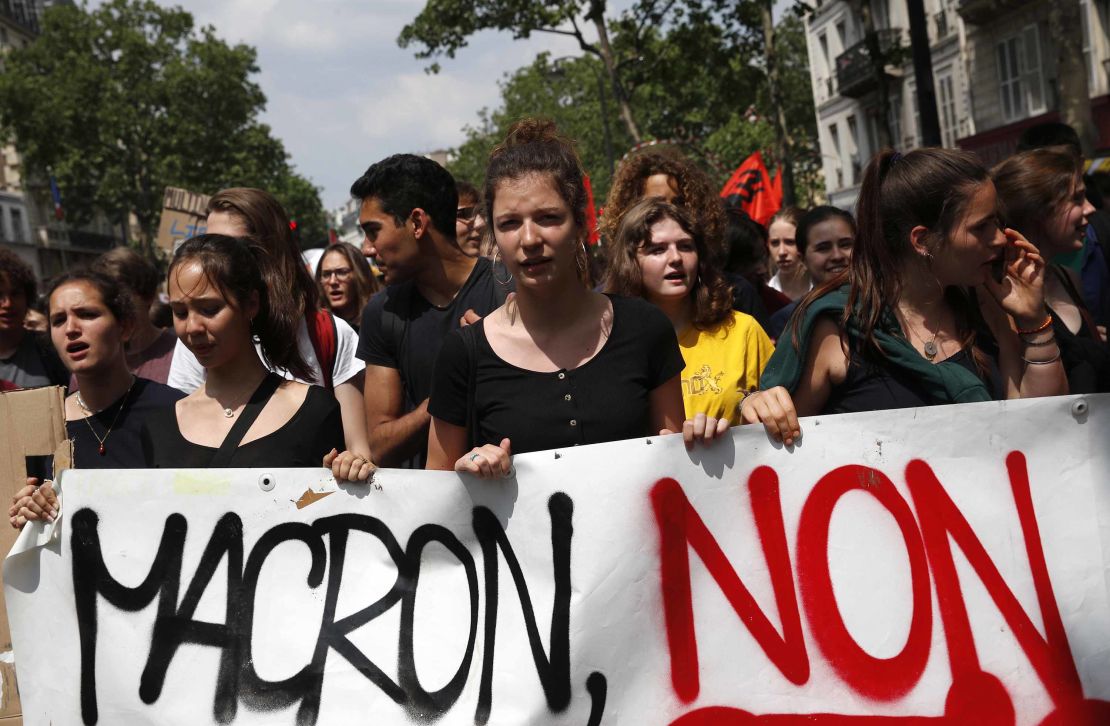Demonstrators carry a banner reading "Macron No" during a strike in Paris.