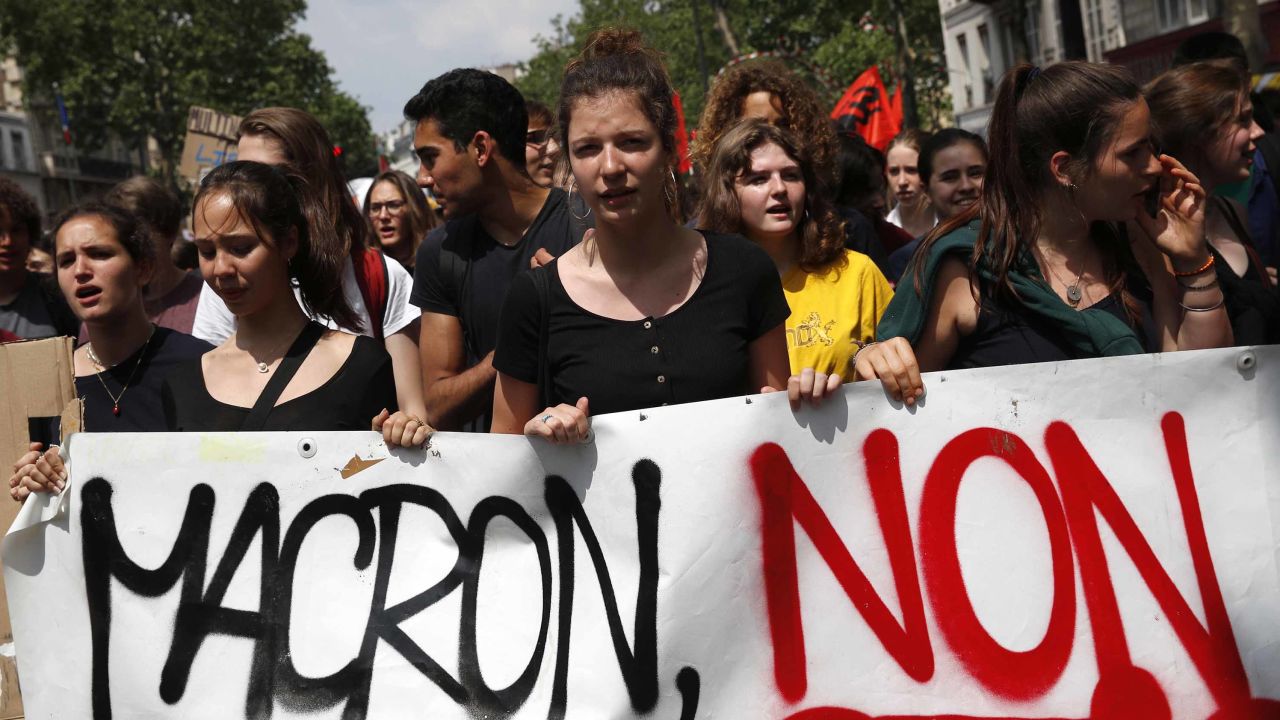 Demonstrators carry a banner reading "Macron No" during a strike in Paris.