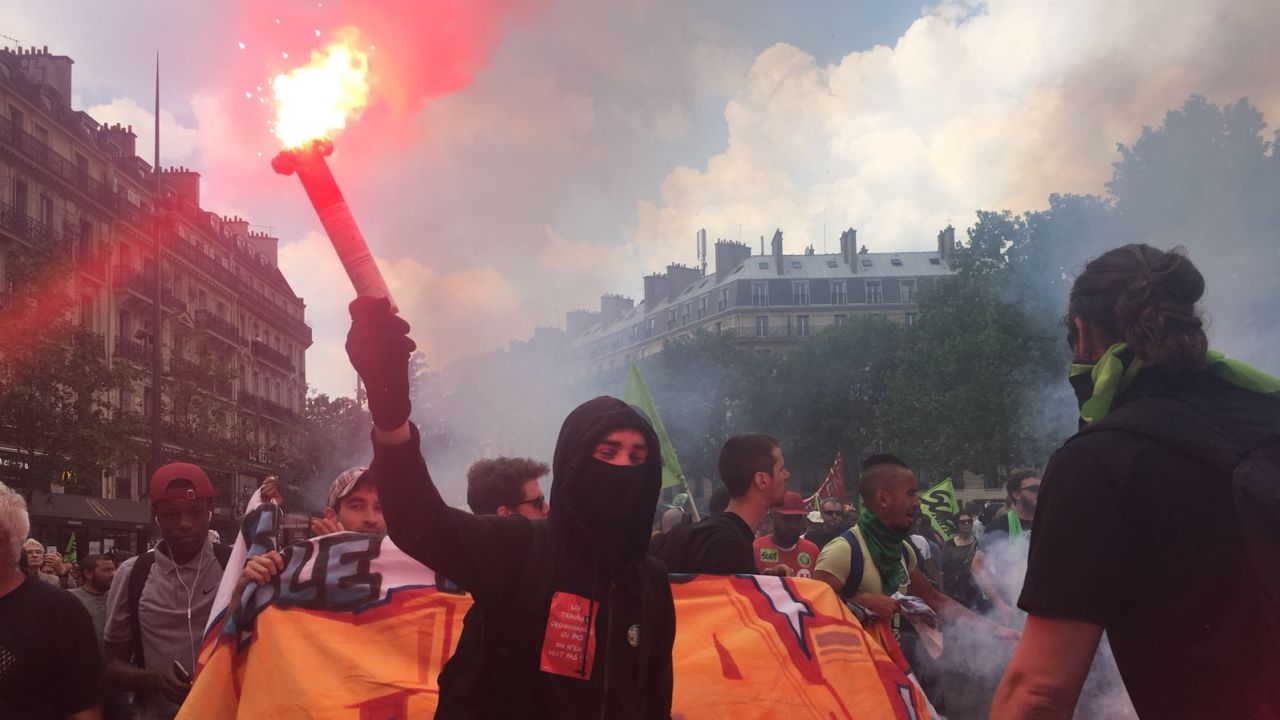 Marchers wave flares at the Place de la République in Paris during nationwide strikes on Tuesday. 