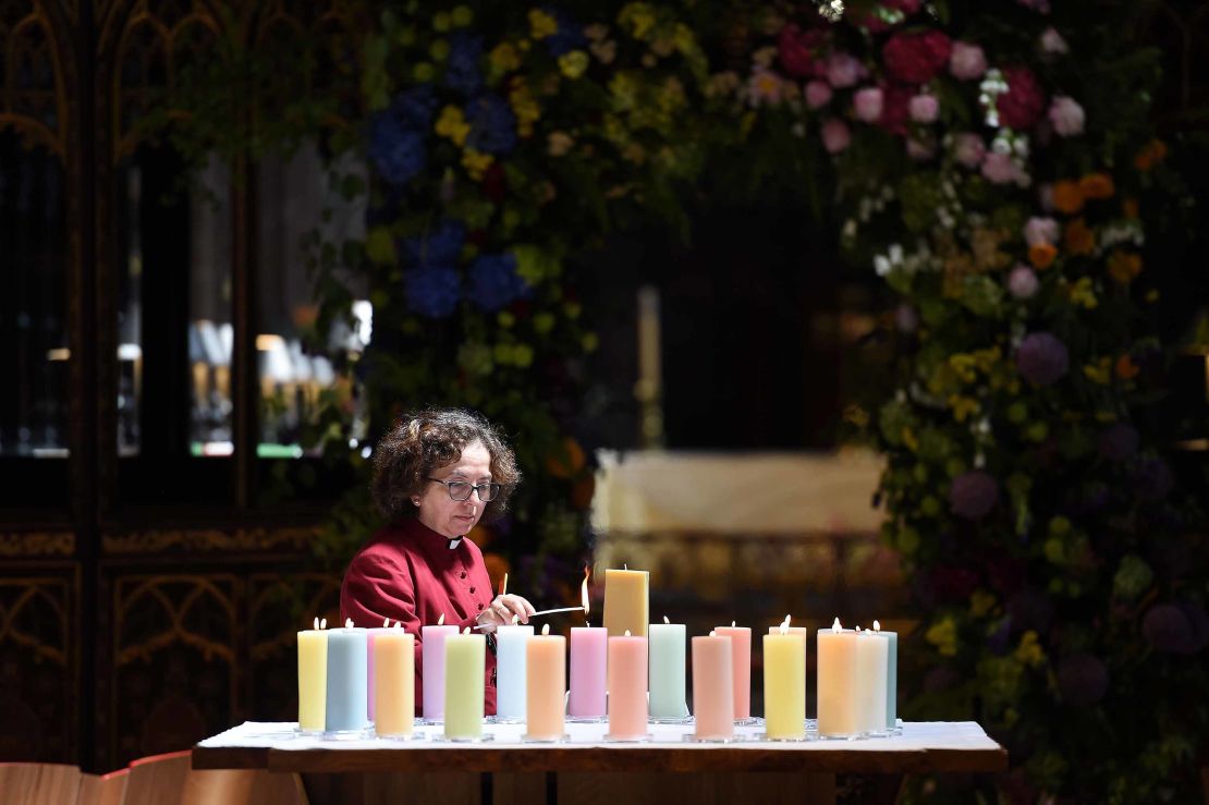 A member of the clergy lights candles for the victims of Mancester Arena attack.