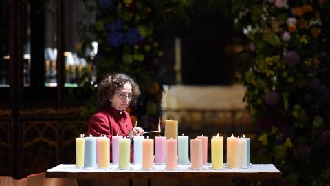 A member of the clergy lights candles for the victims of Mancester Arena attack.