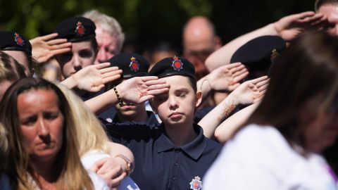 A cadet salutes during a minute's during the outside broadcast of the Manchester Arena commemoration.