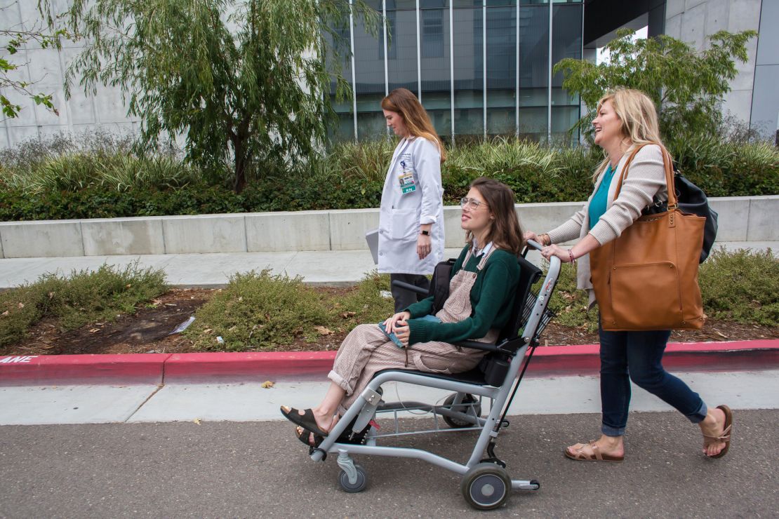 Megan Serletti, top, a nurse who works as a lung transplant coordinator, leads Claire and her mom, Melissa Nordquist Yeager, into the transplantation center.