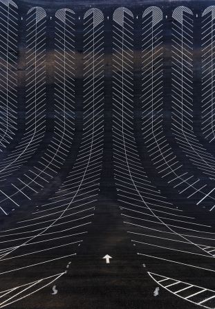 The signage in an empty North American car park looks like a sleek design from above.