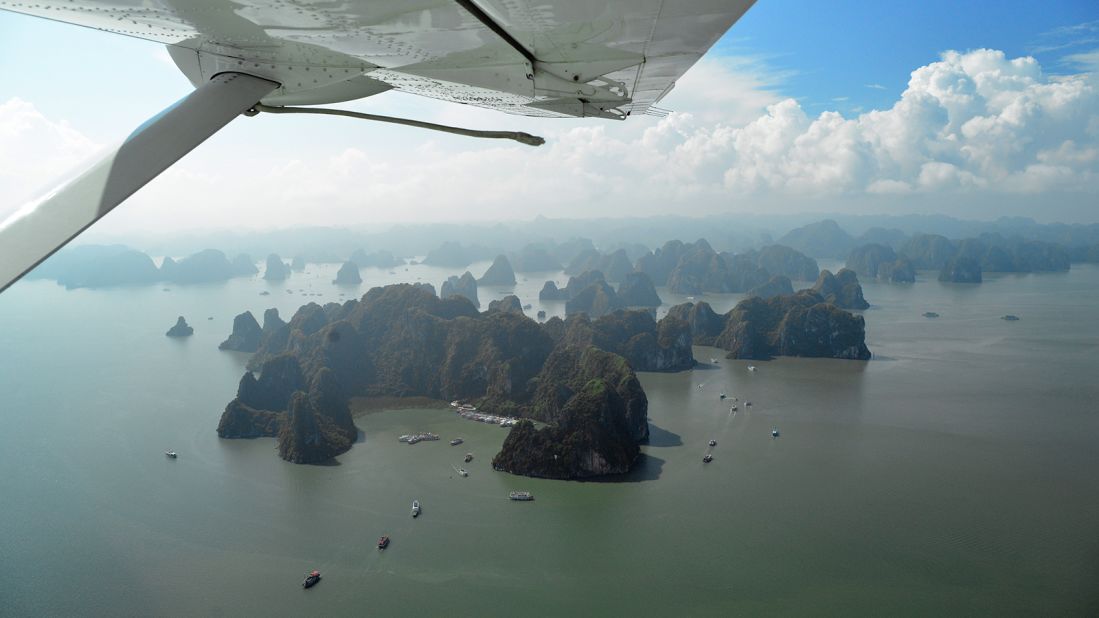 <strong>Halong Bay from above: </strong>The soaring spires of Halong's famous islands rise above the shimmering coastal flatlands like the towers of some gargantuan cityscape.