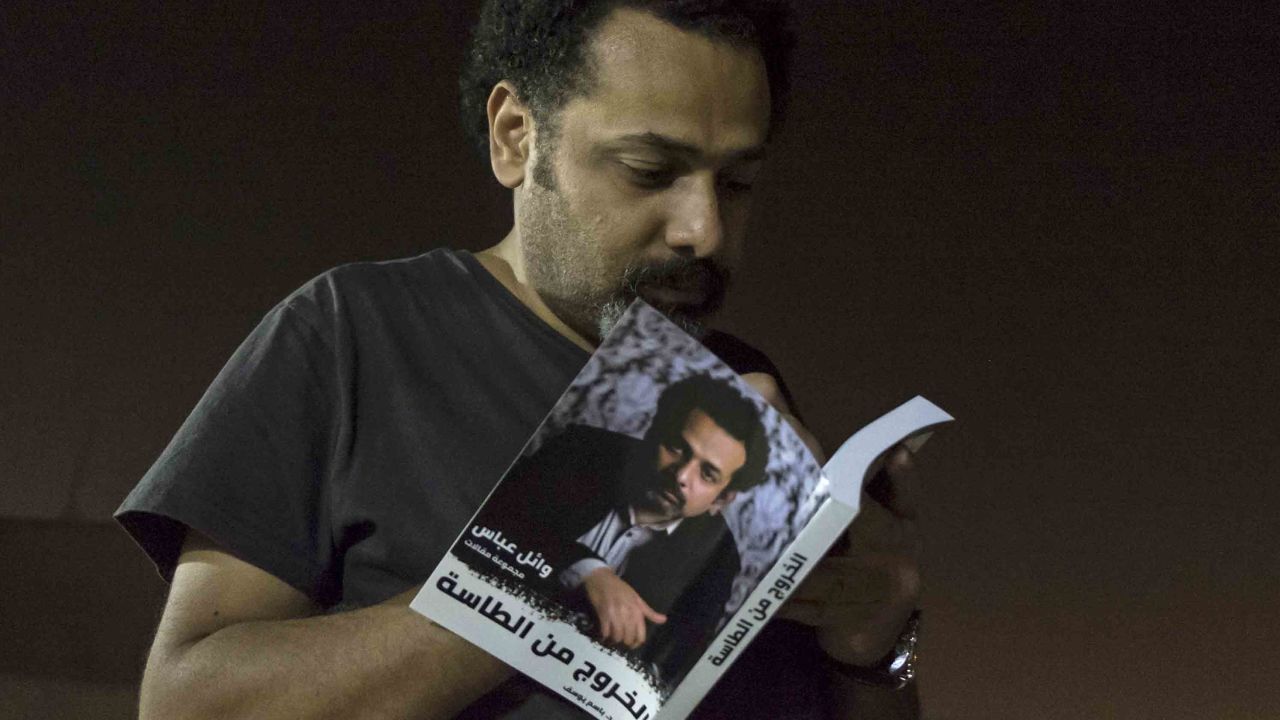 Prominent activist and blogger Wael Abbas signs a copy of his book, "The Theory of Leaving the Bowl," in Cairo.
