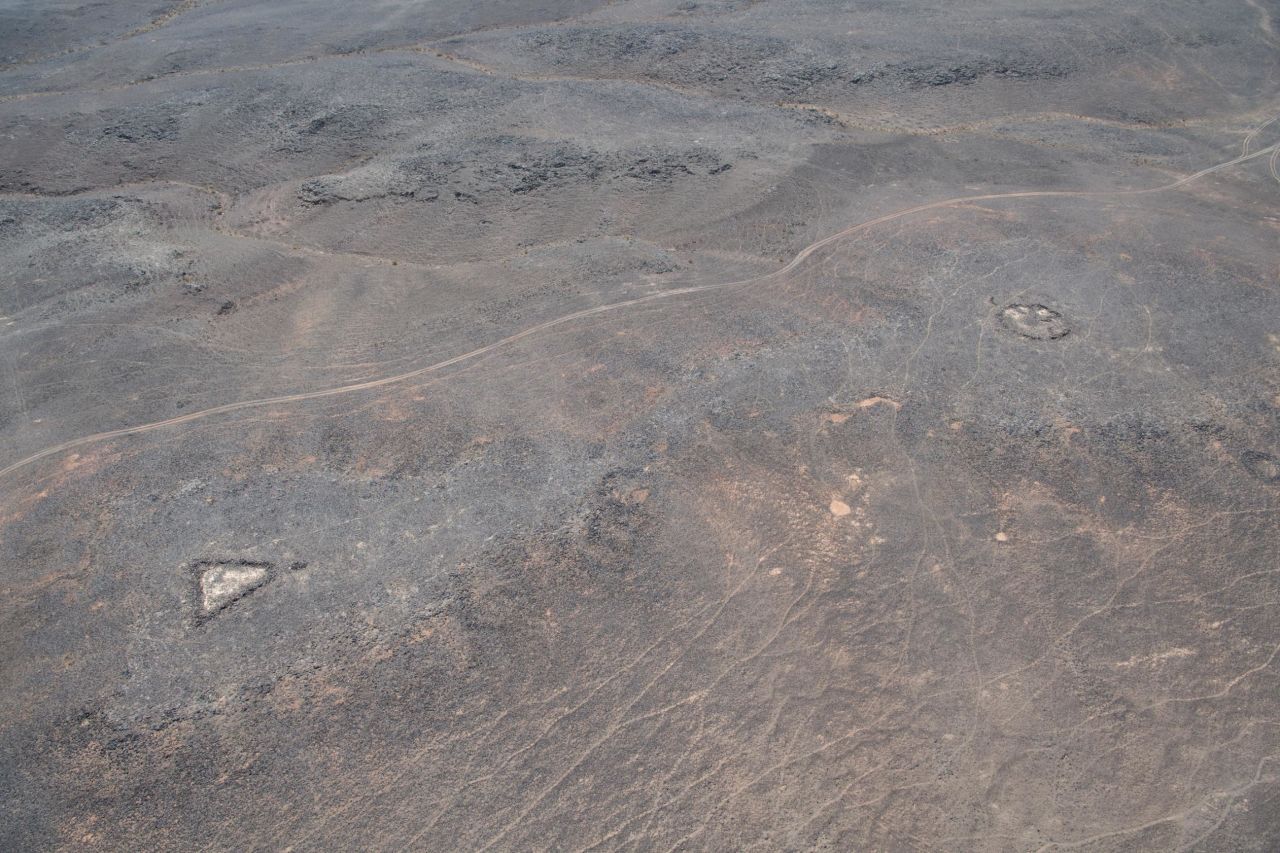 Some of the cairns have one or more associated triangular structures which point towards the grave.