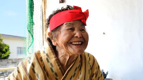 Centenarian Haru Yamashiro has trouble hearing but still moves quickly from place to place. 