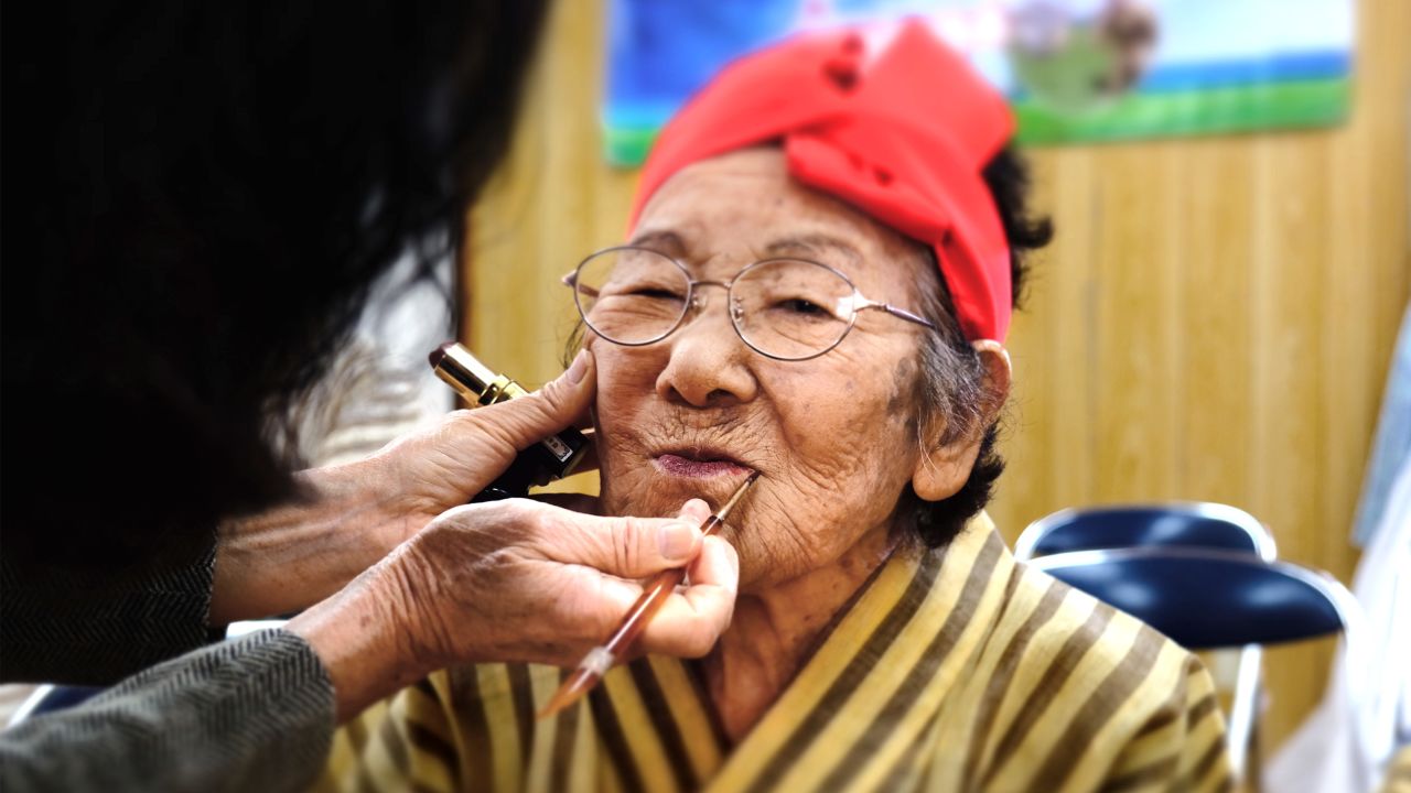 Tomi Menaka, 95, has her makeup done before a KBG48 rehearsal. 