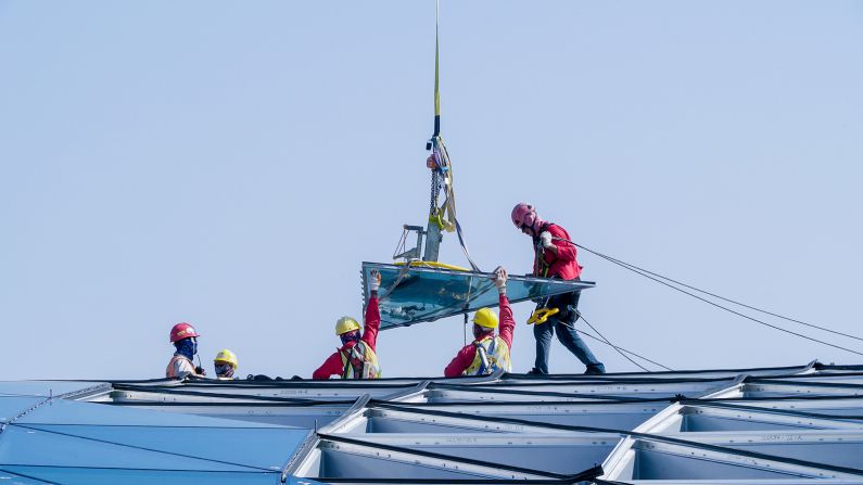 <strong>Installation: </strong>The panel will then be received by a team of waiting abseilers, then drilled into the grid.