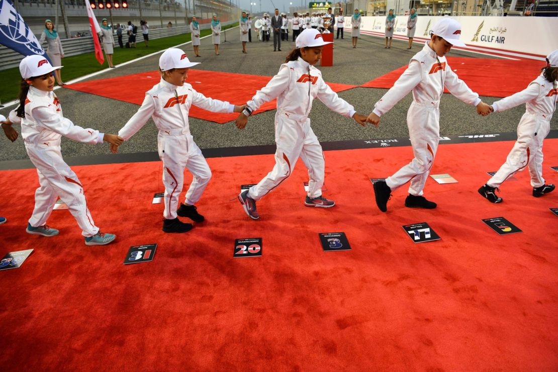 Children walk off the starting grid prior to the Bahrain Formula One Grand Prix on April 8, 2018.