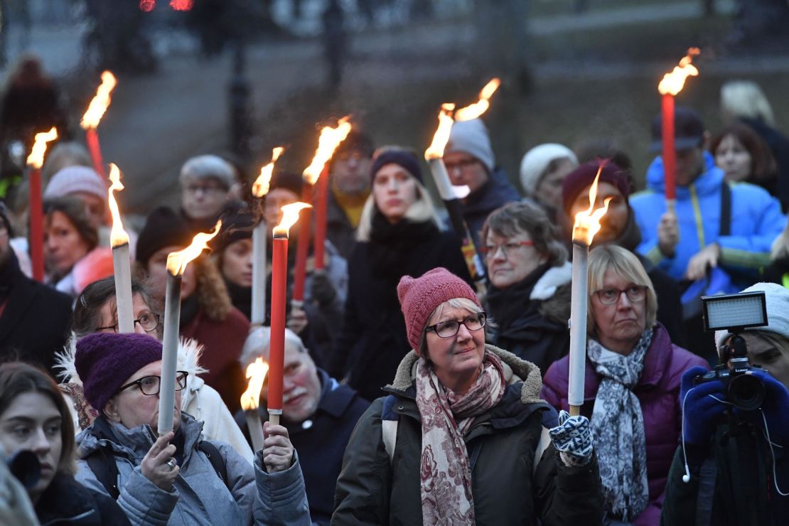 People attend a rally in Stockholm, Sweden, in support of #metoo. 