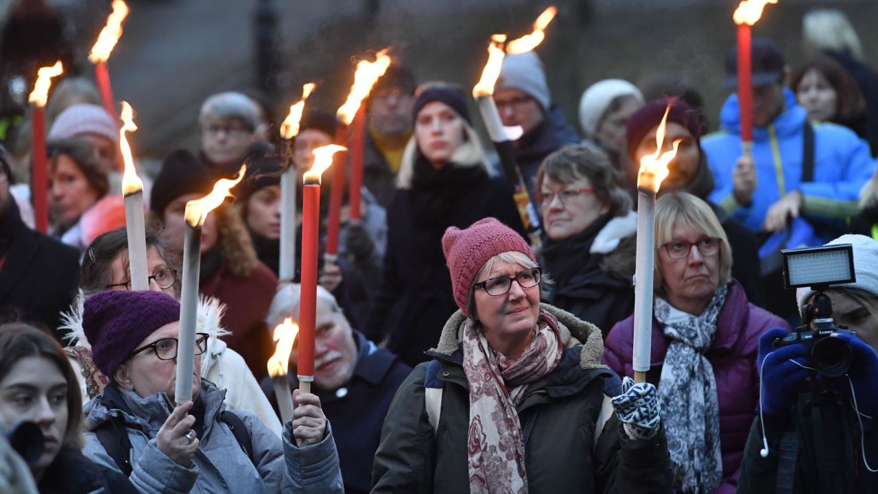 People hold torches during a rally in support of the #MeToo movement in Stockholm in January. 
