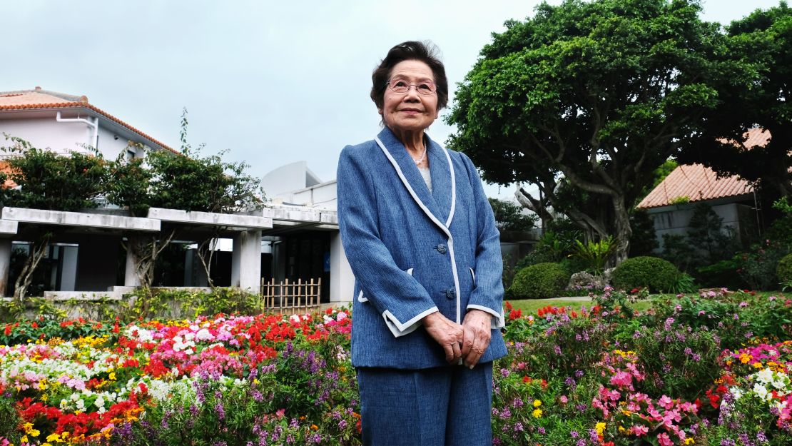 Yoshiko Shimabukuro stands in the garden area of the Himeyuri Peace Museum, which she helped establish. 