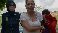 Australian national Maria Elvira Pinto Exposto (C) is escorted by a Malaysian custom official as she arrives at the Magistrate Court in Sepang on April 30, 2015. An Australian woman faces a possible death sentence for drug trafficking in Malaysia after a prosecutor said on April 30 a chemist's report confirmed the substance found in her bag was crystal methamphetamine. AFP PHOTO / MOHD RASFAN        (Photo credit should read MOHD RASFAN/AFP/Getty Images)