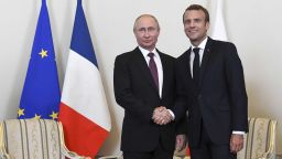Russian President Vladimir Putin, right, shakes hands with French President Emmanuel Macron, during their meeting in St. Petersburg, Russia, Thursday, May 24, 2018. Macron's talks with Putin are set to focus on the U.S. exit from the Iranian nuclear deal, as well as conflict in Syria and Ukraine. (Kirill Kudryavtsev/Pool Photo via AP)