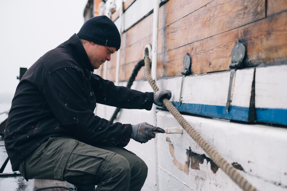Mads Hansen paints the ship as part of ongoing maintenance.