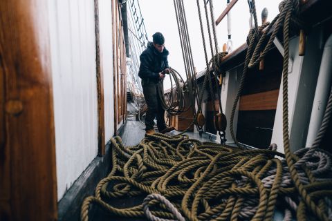 Tobias Soerensen tidies ropes on the Linden's deck during it's voyage to Svalbard.