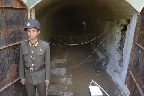 A soldier stands at the entrance to tunnel 3.