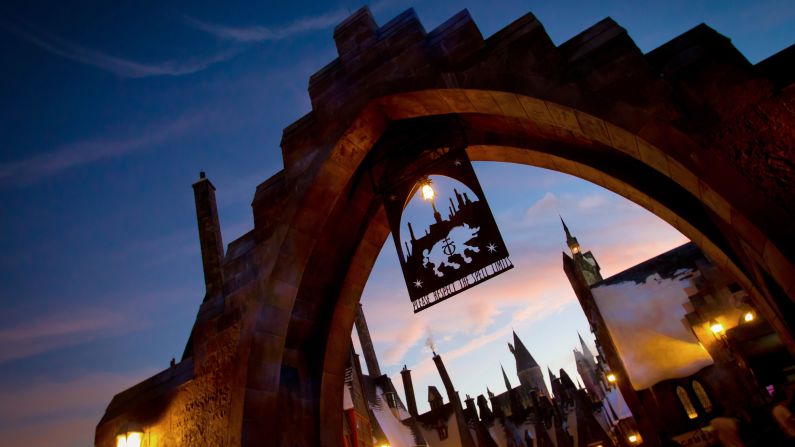<strong>The Wizarding World of Harry Potter. </strong>First-time and returning Hogwarts students and visitors stroll under a metal arch to enter Hogsmeade. 