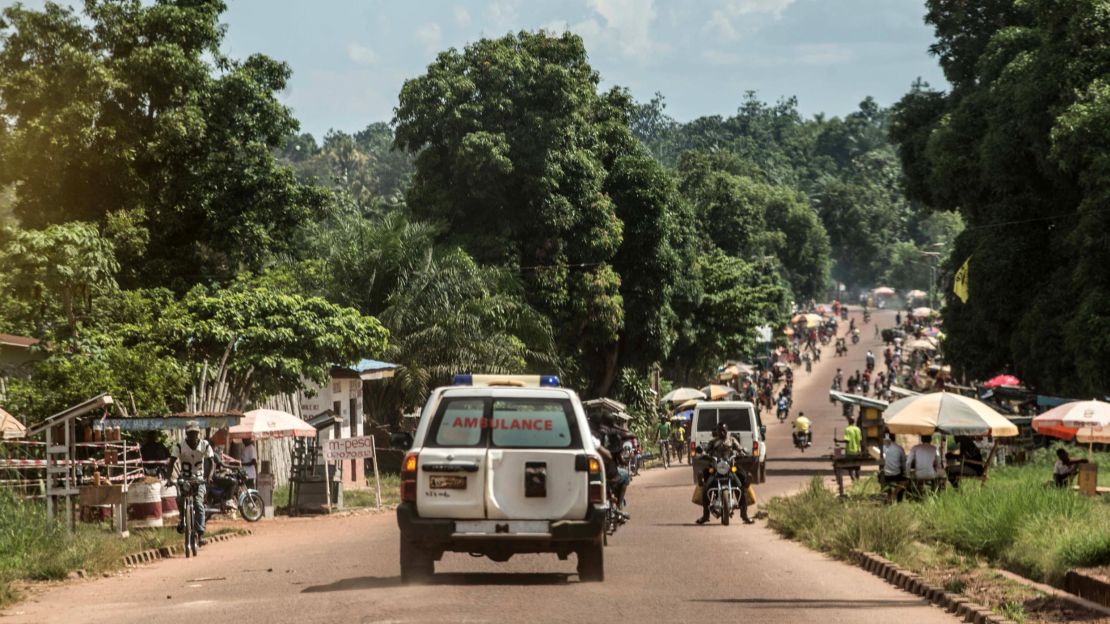 An ambulance carries an Ebola victim to a burial site in Mbandaka.